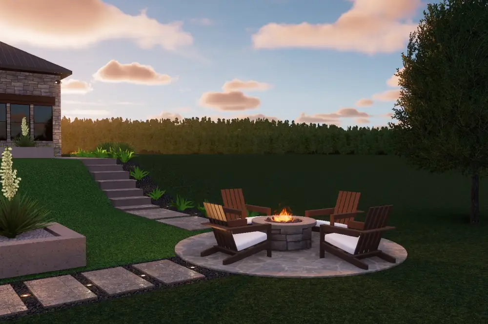 A cozy fire pit area featuring wooden chairs surrounded by lush greenery and a modern home under a colorful sunset sky