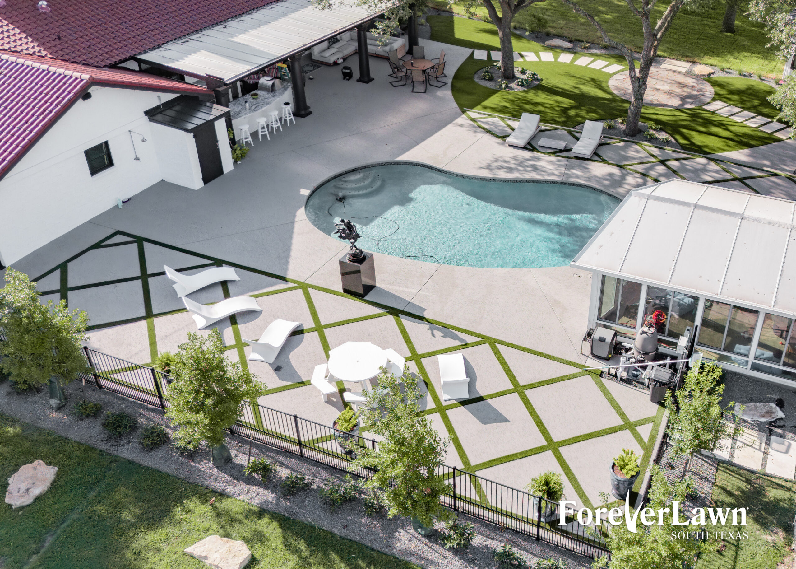 A spacious backyard features a swimming pool with stairs, surrounded by green grass and potted plants, under a stormy sky